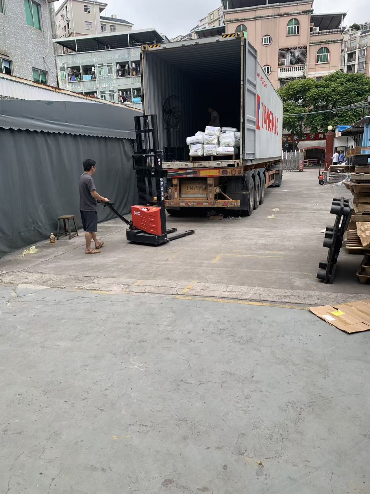 EP Equipment F3 electric pallet truck moving standardized export cargo into a Yang Ming container at Sealock shipping bay. EP Equipment F3 electric pallet truck moving standardized export cargo into a Yang Ming container at Sealock shipping bay.
