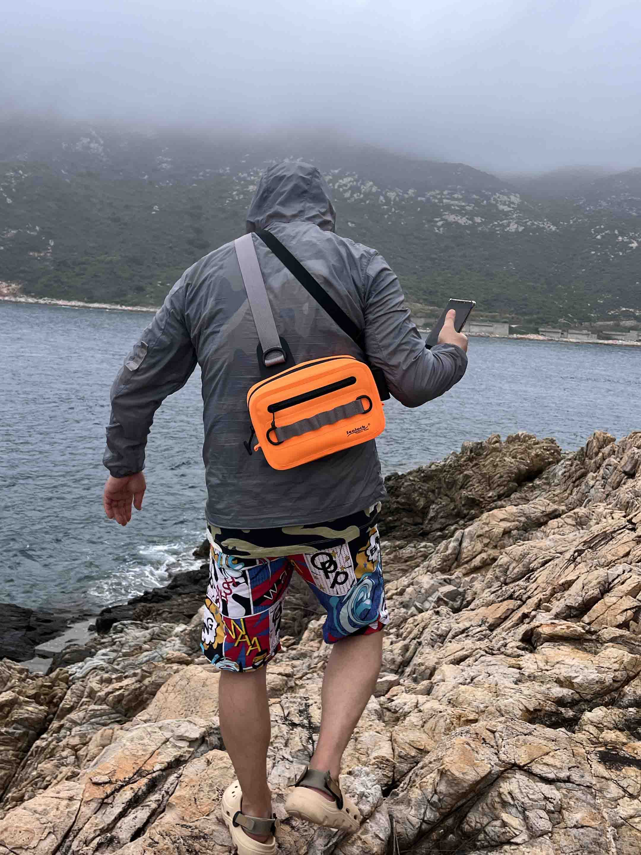 waterproof sling waist pack with airtight zipper worn crossbody
